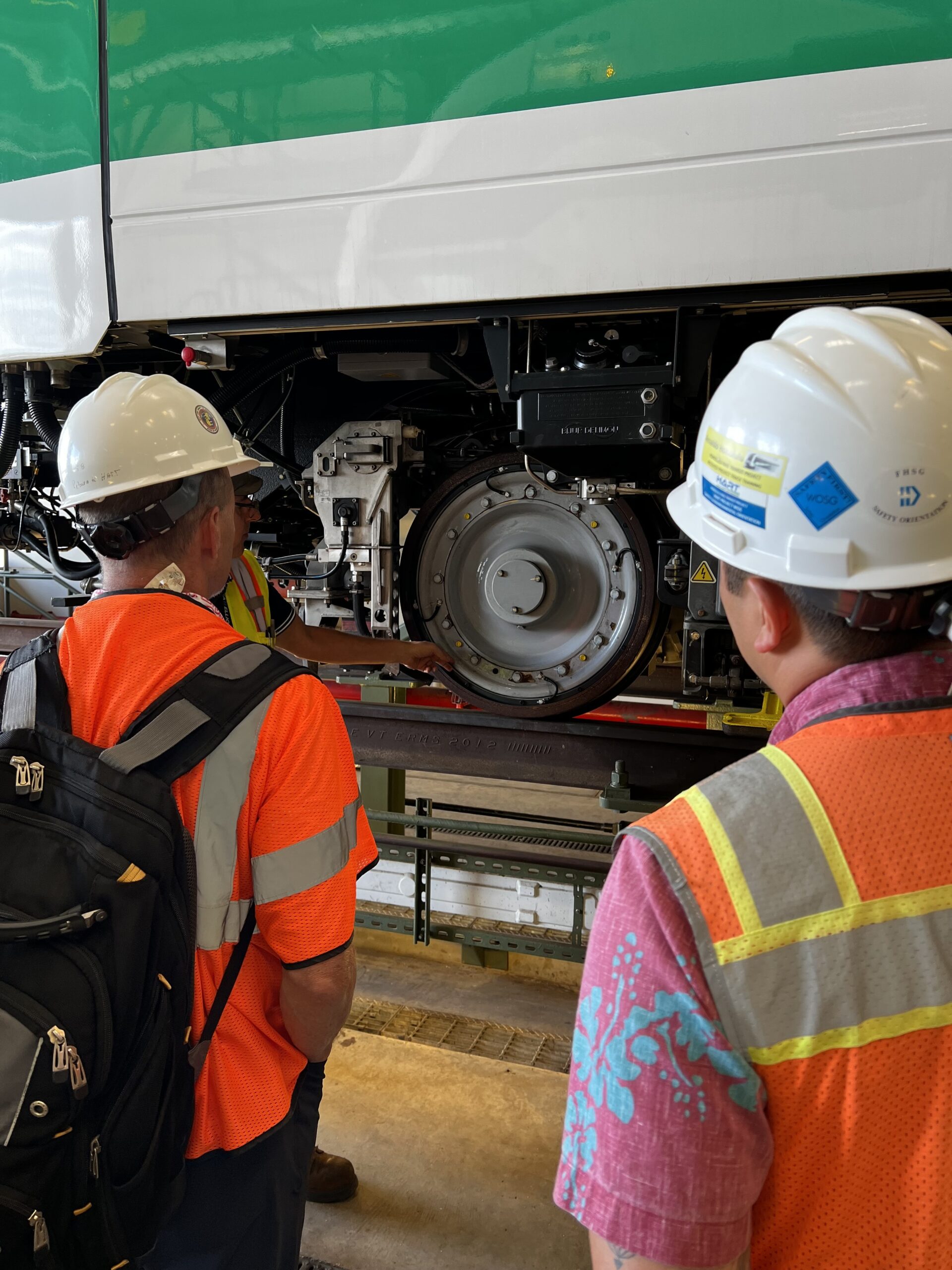 Workers inspecting a metro train