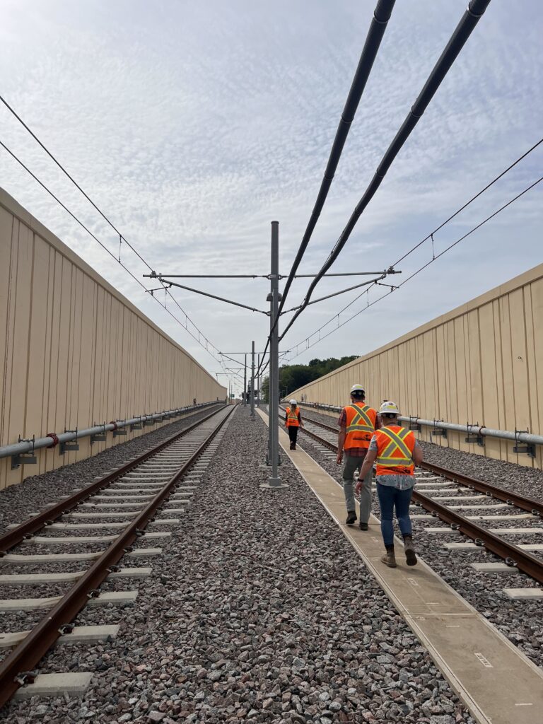 Workers inspecting light rail track