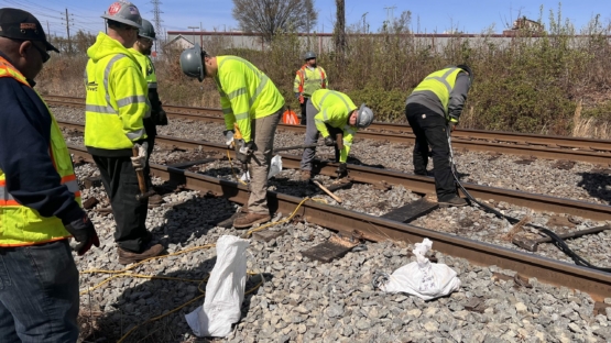 Workers repairing light rail track